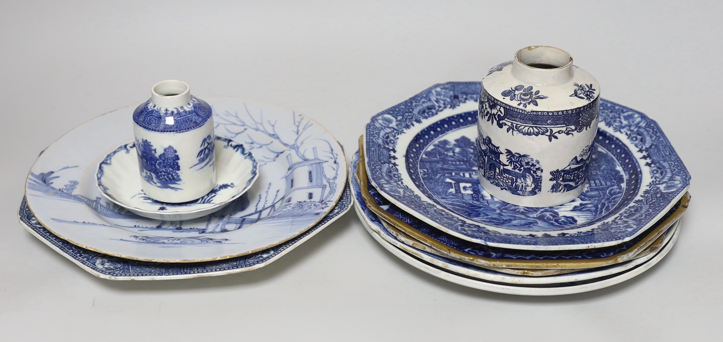 A collection of pearlware blue and white plates and two tea canisters, c.1790-1810, A Worcester Hollow Rock pattern saucer and an English delftware plate painted with Chinese figures, 23cm diameter